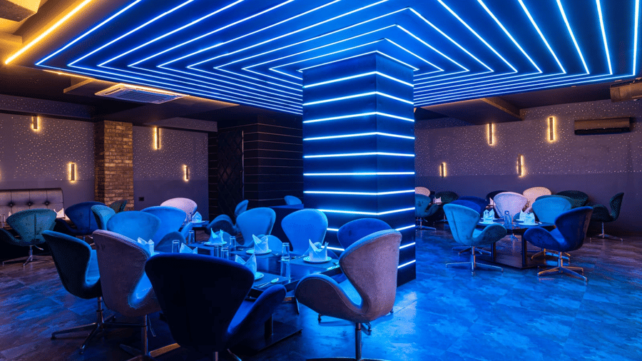 Indoor restaurant area showcasing a geometric ceiling design and comfortable seating for guests at Re-Pub-Liq, Papaya Tree Hotels