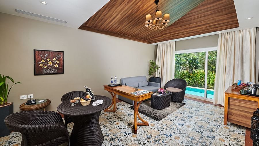 Living area of a room at Swosti Chilika Resort with sofa and coffee table arrangement