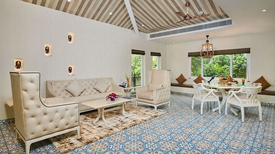 Sofa seating and dining set up in the living area at Swosti Chilika Resort