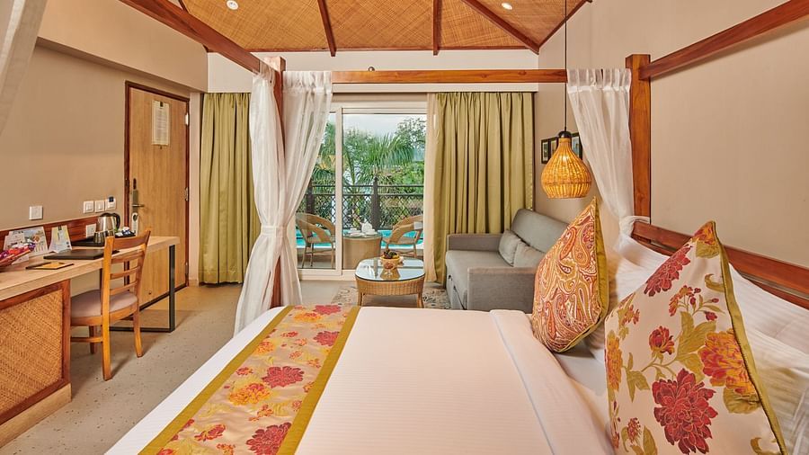 A room at Swosti Chilika Resort with a double bed and large windows