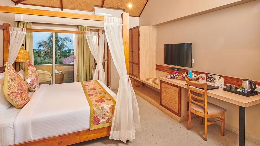 A room at Swosti Chilika Resort with a double bed and a television