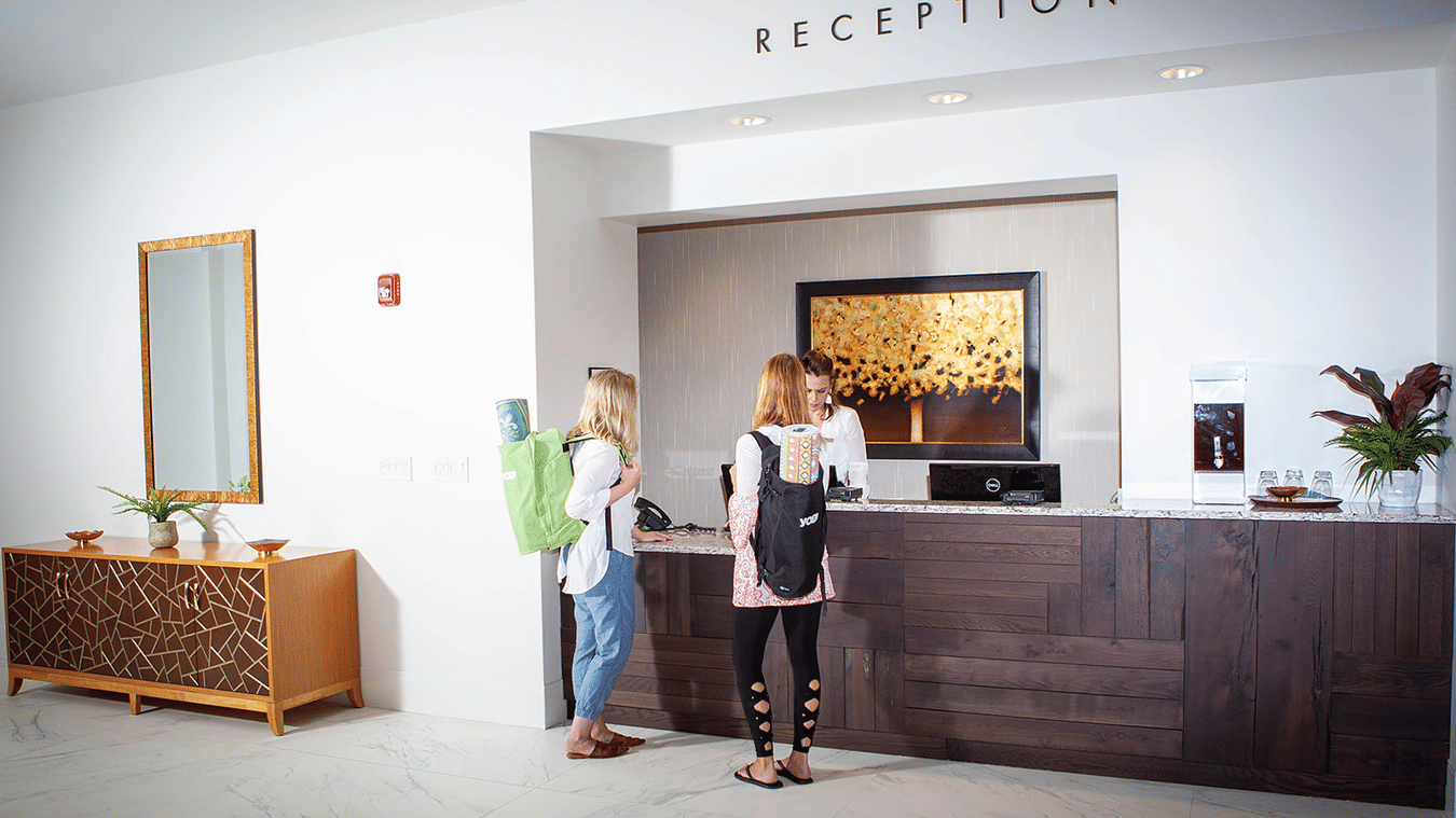 The reception area at YO1 Longevity & Health Resorts, with staff welcoming guests to the wellness retreat