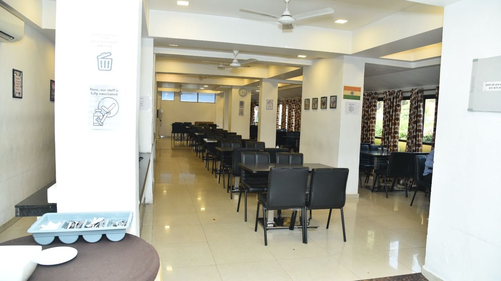 The Darbar Restaurant at Highland Resort features dining tables, and ample lighting.