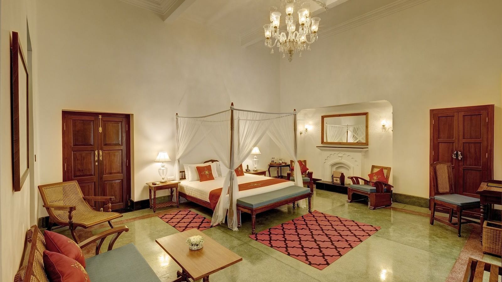 Saraca Suite at Saraca Hotel, Lucknow with a double bed and a chandelier hanging from the ceiling