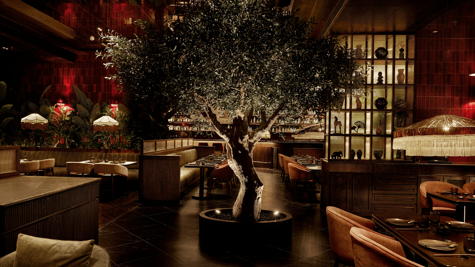 Chic indoor bar with a central tree and cozy seating