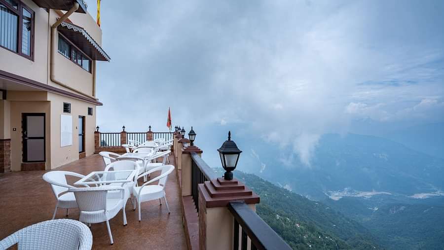 Image of an open dining space and view of the mountains in front at Summit Sherpa Mountain Hotel & Spa, Kalimpong