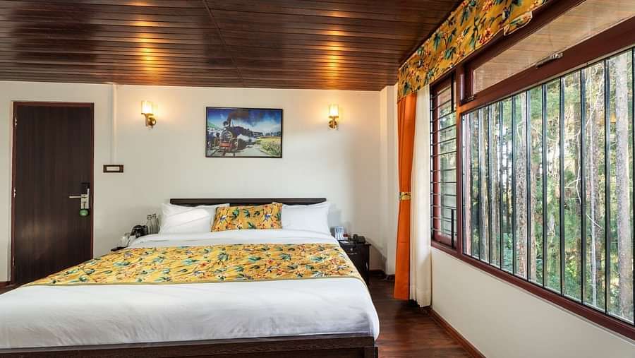Image of a room with bed and and wooden ceiling at Summit Sherpa Mountain Hotel & Spa, Kalimpong