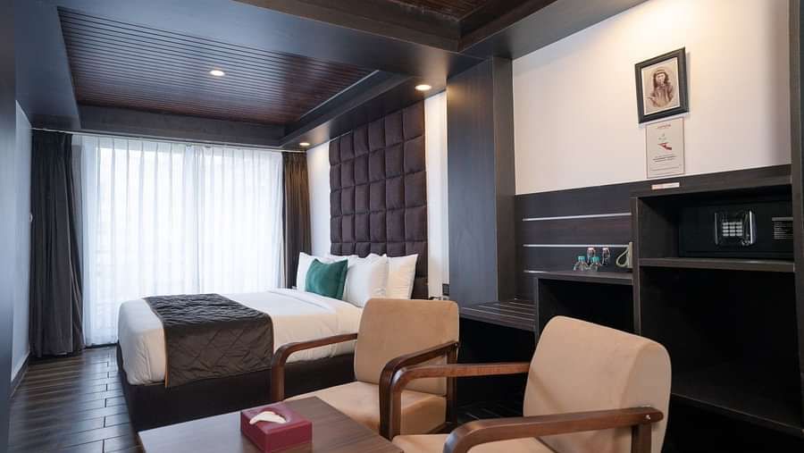 Image of a room that is well furnished with a king size bed and also has an access to a private balcony.