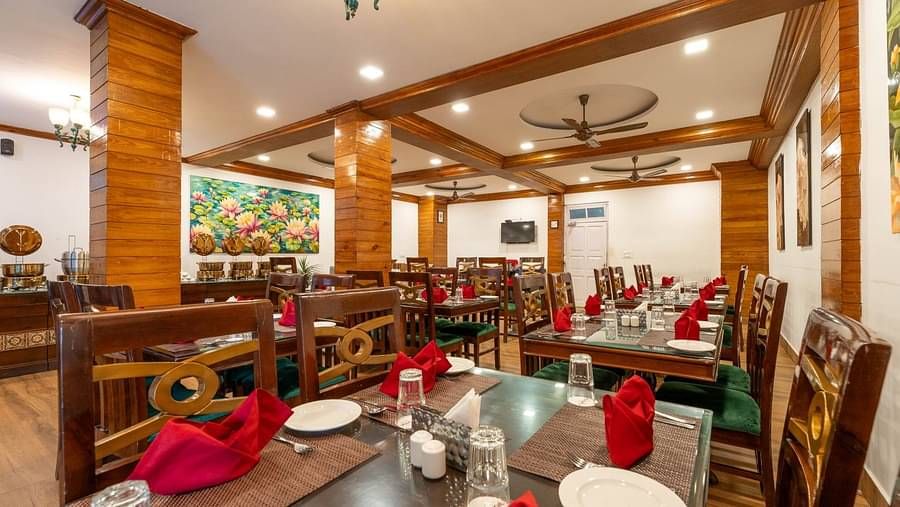Dining arrangement in the restaurant at Summit Barsana Resort & Spa, Kalimpong