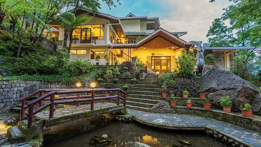 Hotel facade with stairs leading from the pond to the Tsomgo