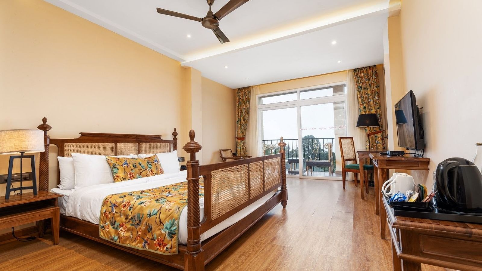 A room at Summit Barsana Resort & Spa, Kalimpong with a double bed and large windows