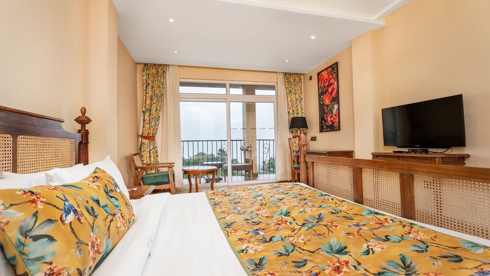 A room at Summit Barsana Resort & Spa, Kalimpong with a double bed, a television and large windows