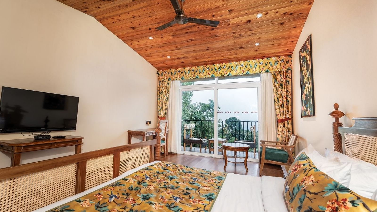 A room at Summit Barsana Resort & Spa, Kalimpong with a double bed, a television and a balcony