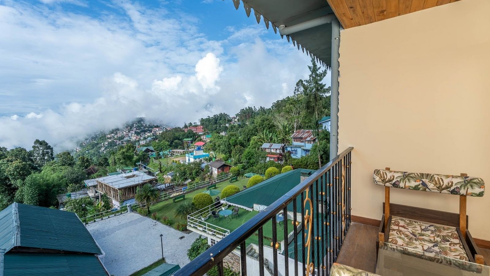 Seating arrangement in a balcony of a room at Summit Barsana Resort & Spa, Kalimpong
