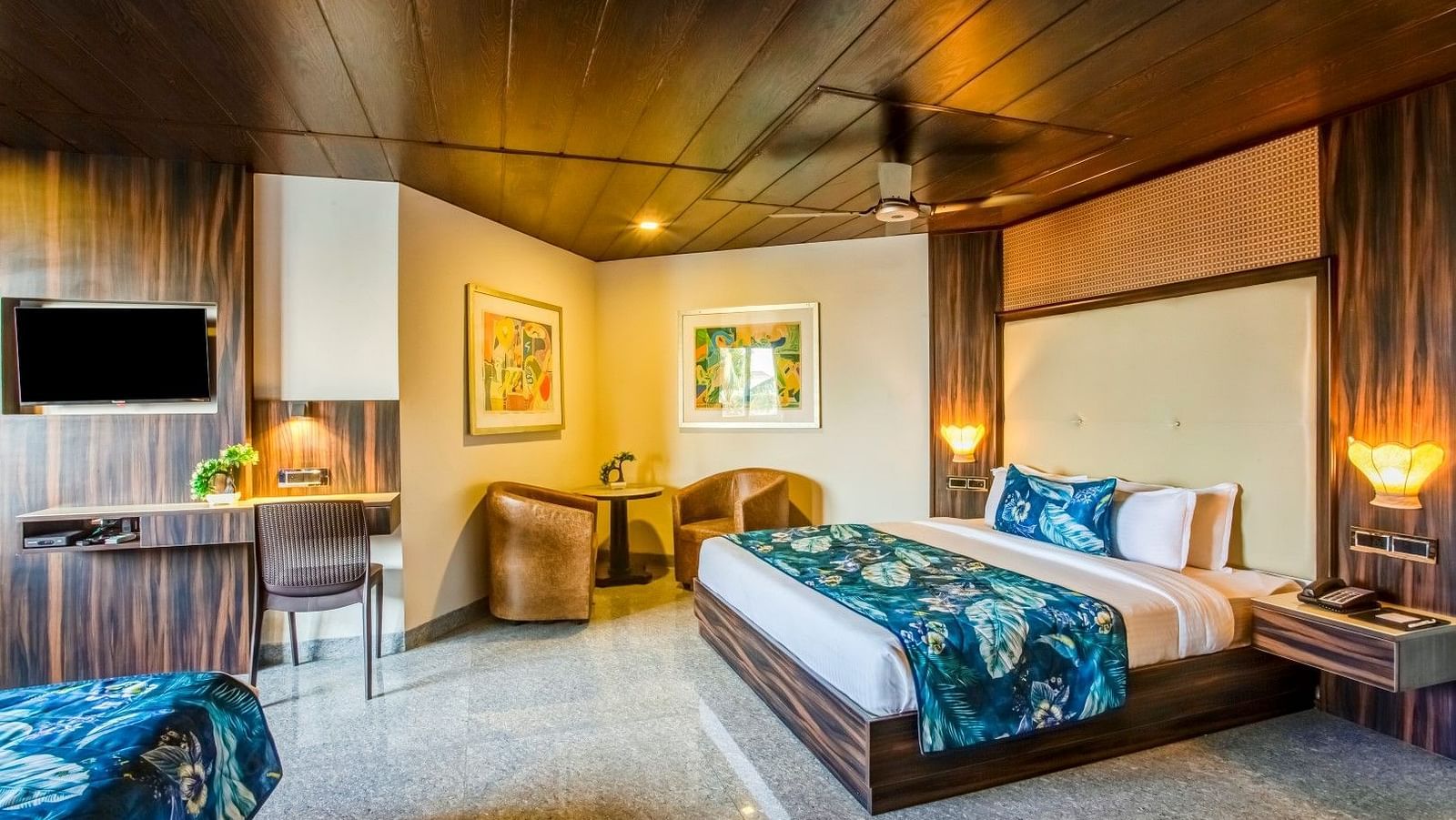 Generously sized bed flanked by two cushioned sofas with a sturdy table placed between them