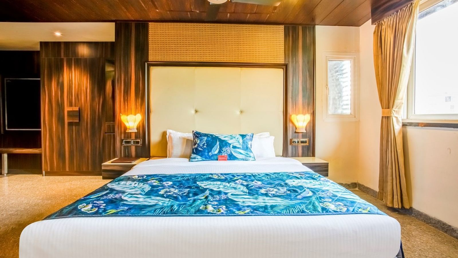  Spacious bed with two bedside tables, each adorned with a lamp, viewed from the front