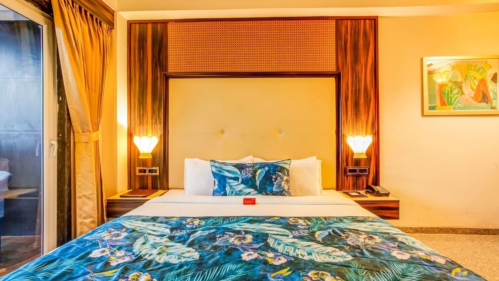  Spacious bed with two bedside tables, each adorned with a lamp, viewed from the front