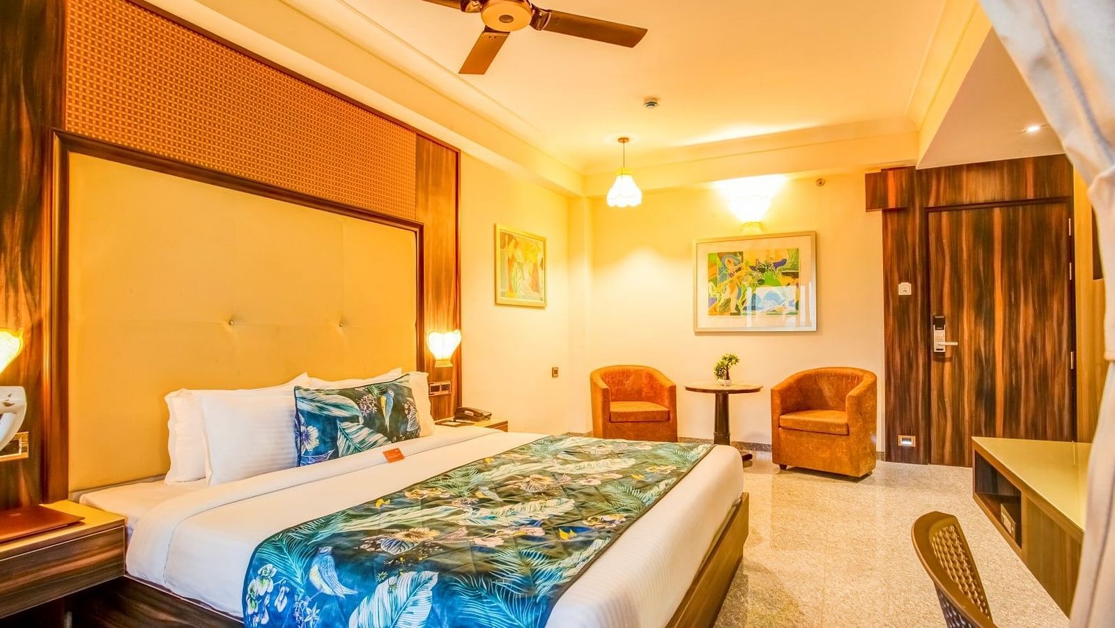  Generously sized bed flanked by two cushioned sofas with a sturdy table placed between them