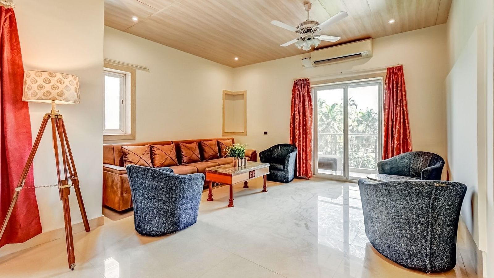 Two sofas positioned opposite each other with a table between them, complemented by a large side sofa adorned with pillows