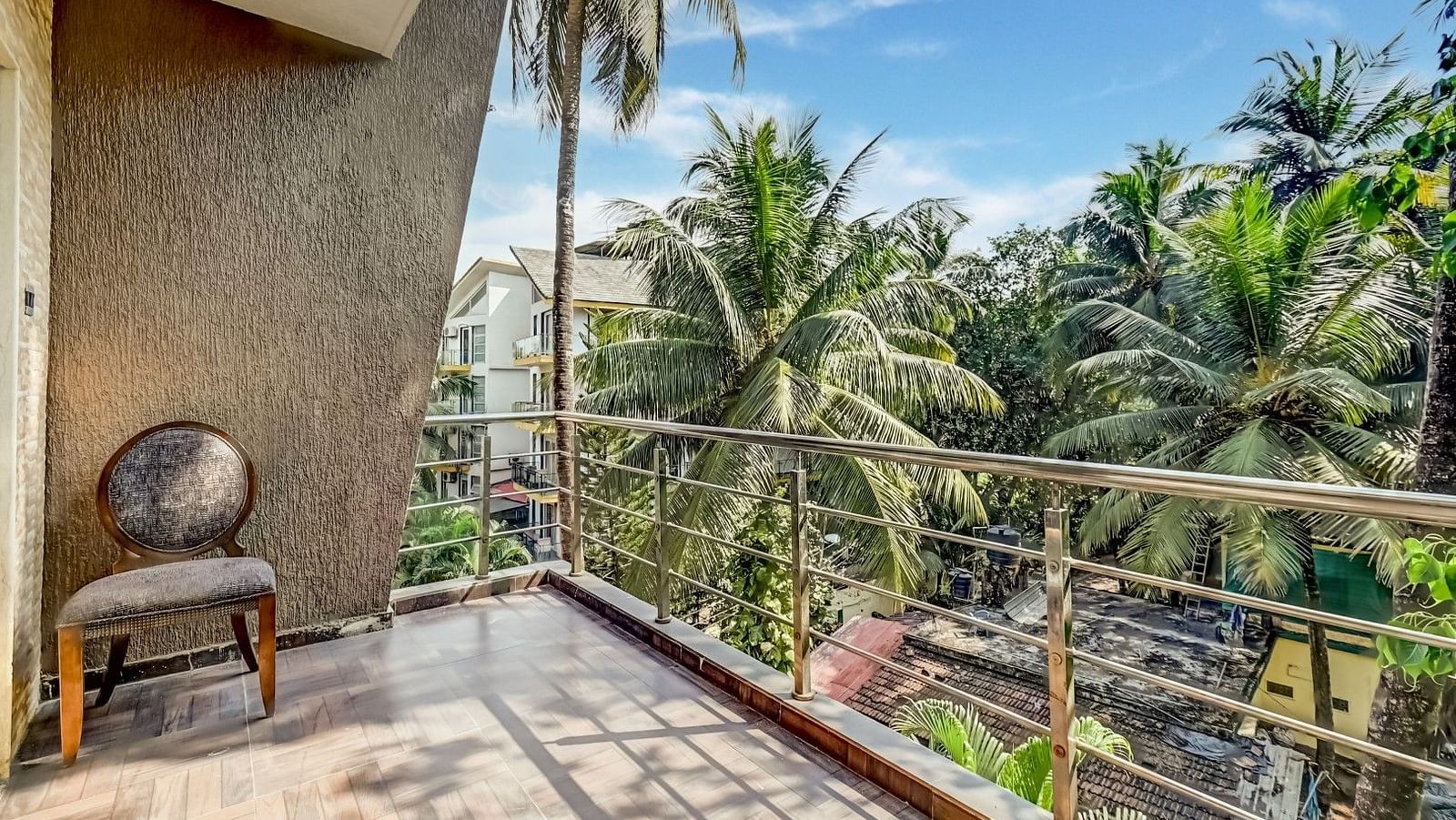Balcony offering a delightful view of the lush, green coconut trees