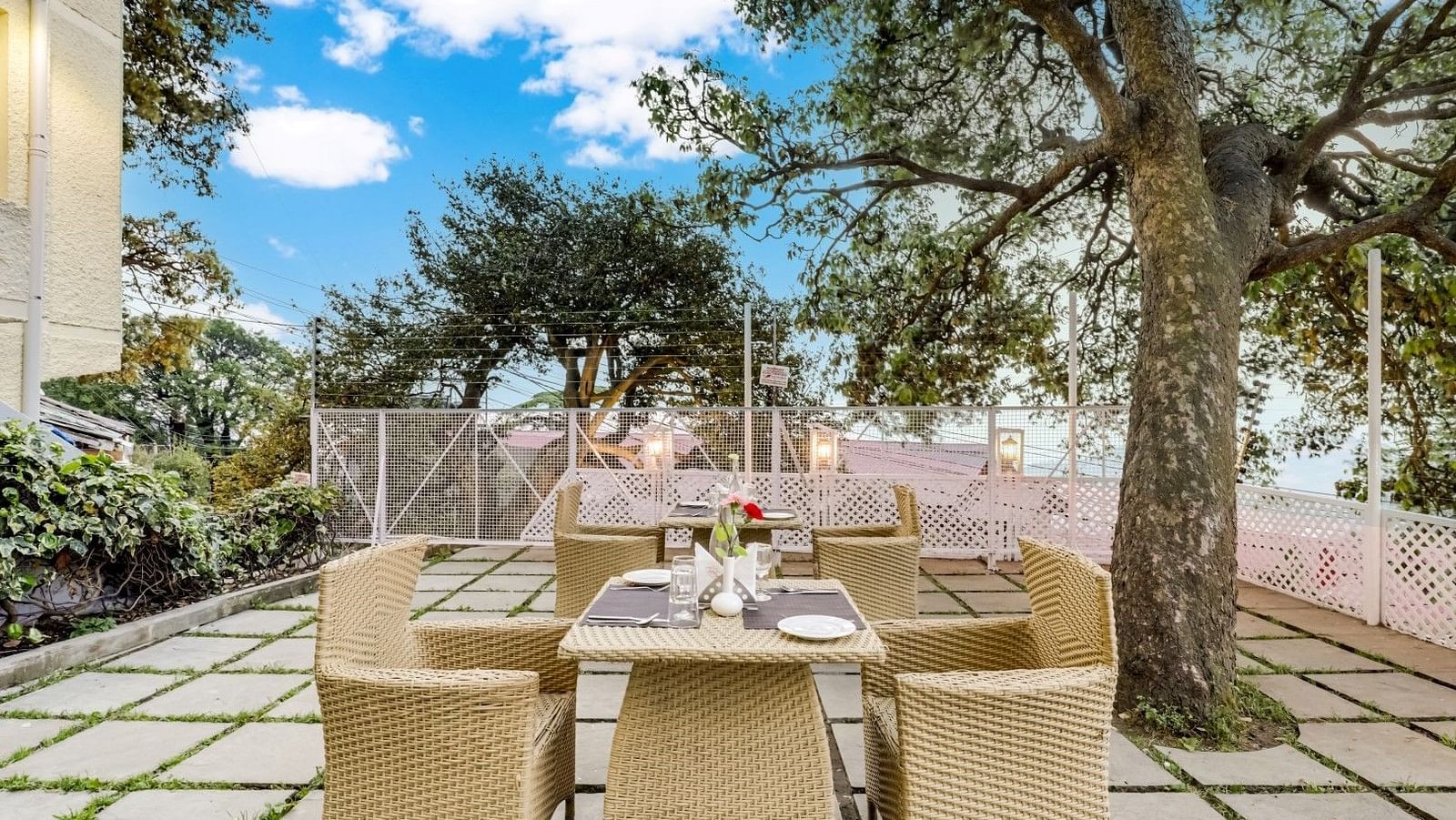 Outdoor dining area with a beautifully arranged table set for guests at Summit Le Royale Hotel in Shimla