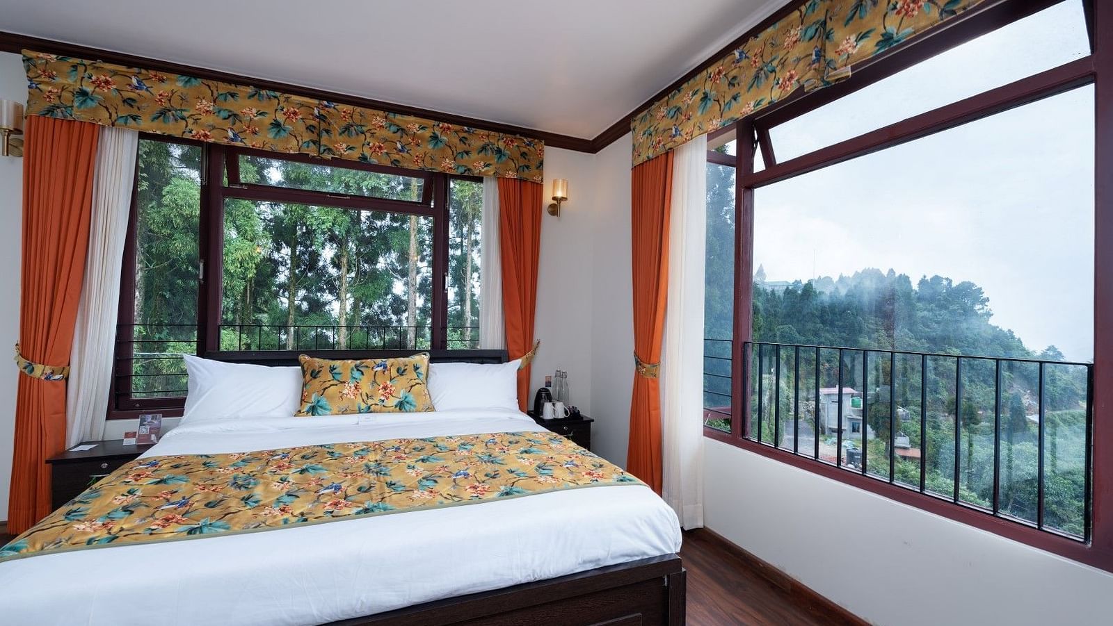 Image of a room with bed and large windows with view of the mountians at Summit Sherpa Mountain Hotel & Spa, Kalimpong