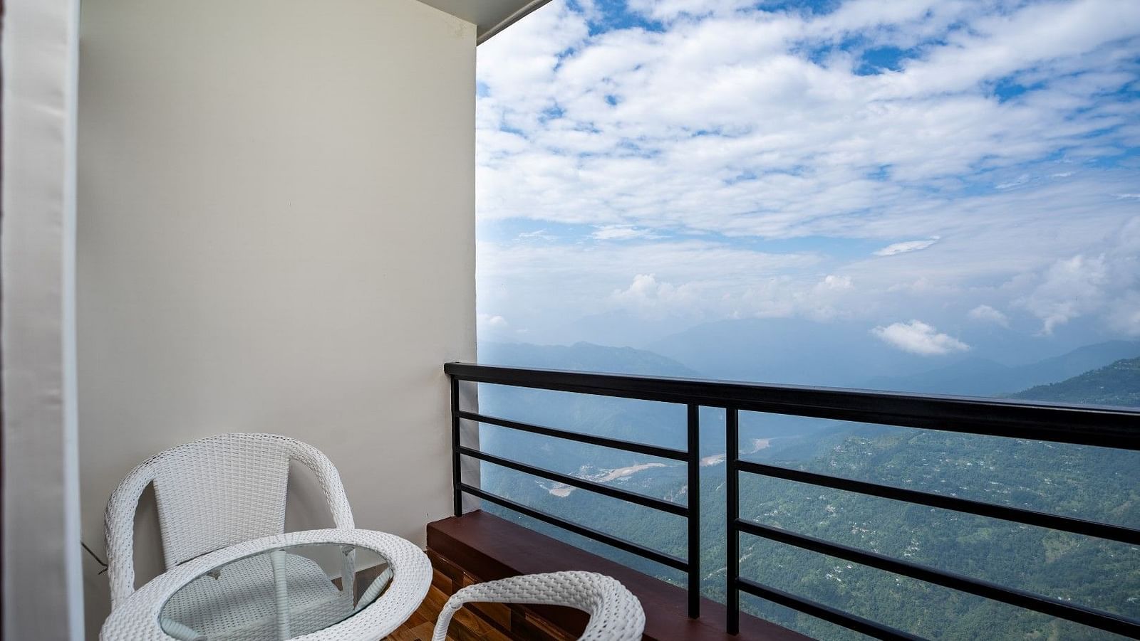 Image of an open seating space with view of the mountains at Summit Sherpa Mountain Hotel & Spa, Kalimpong