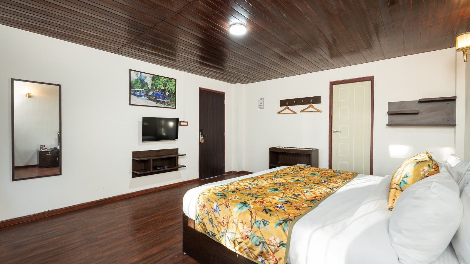 Image of a room with bed and mirror on the wall at Summit Sherpa Mountain Hotel & Spa, Kalimpong