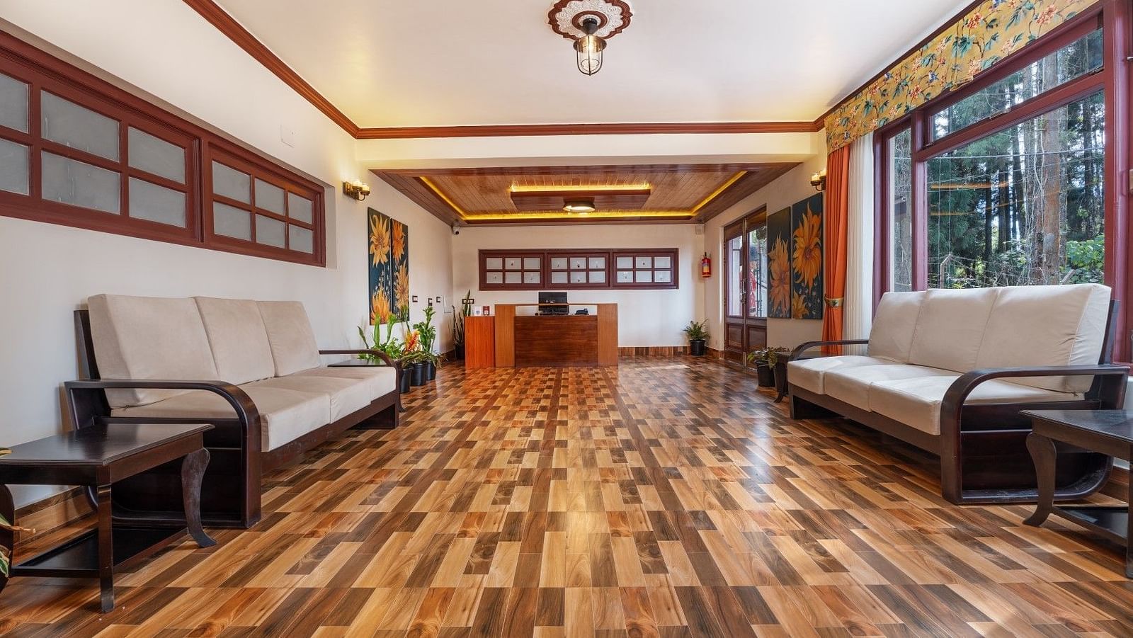Image of a seating area with sofas and large windows at Summit Sherpa Mountain Hotel & Spa, Kalimpong