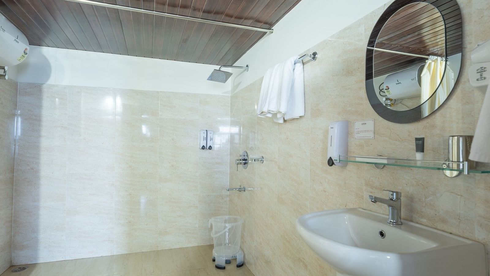 Image of a washroom with round mirror and sperate showering area at Summit Sherpa Mountain Hotel & Spa, Kalimpong