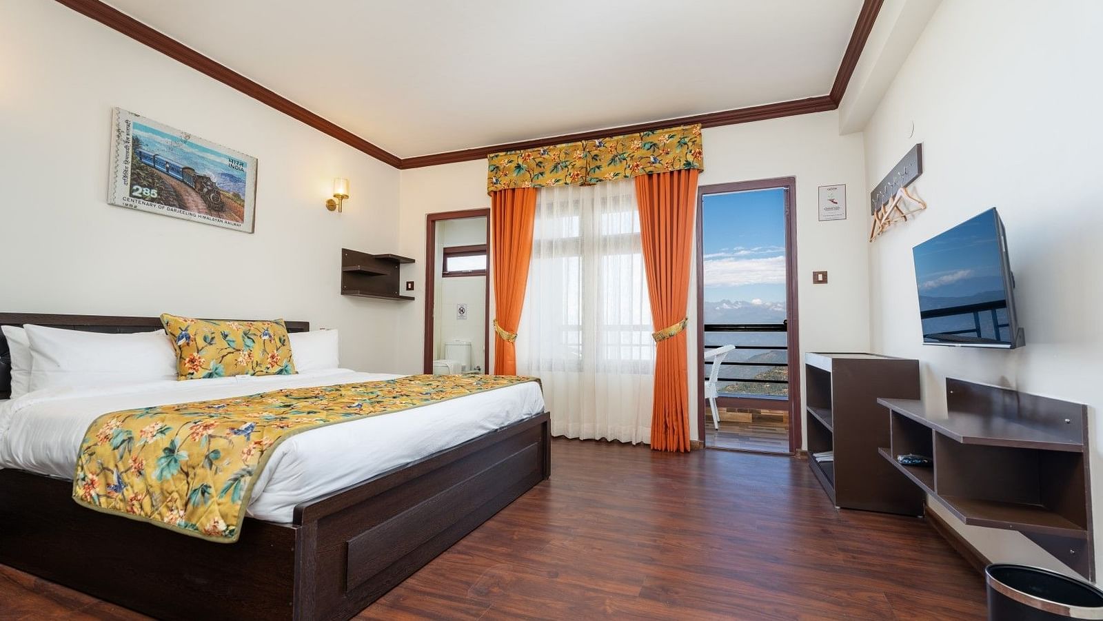 Image of a room with large bed and television in front at Summit Sherpa Mountain Hotel & Spa, Kalimpong