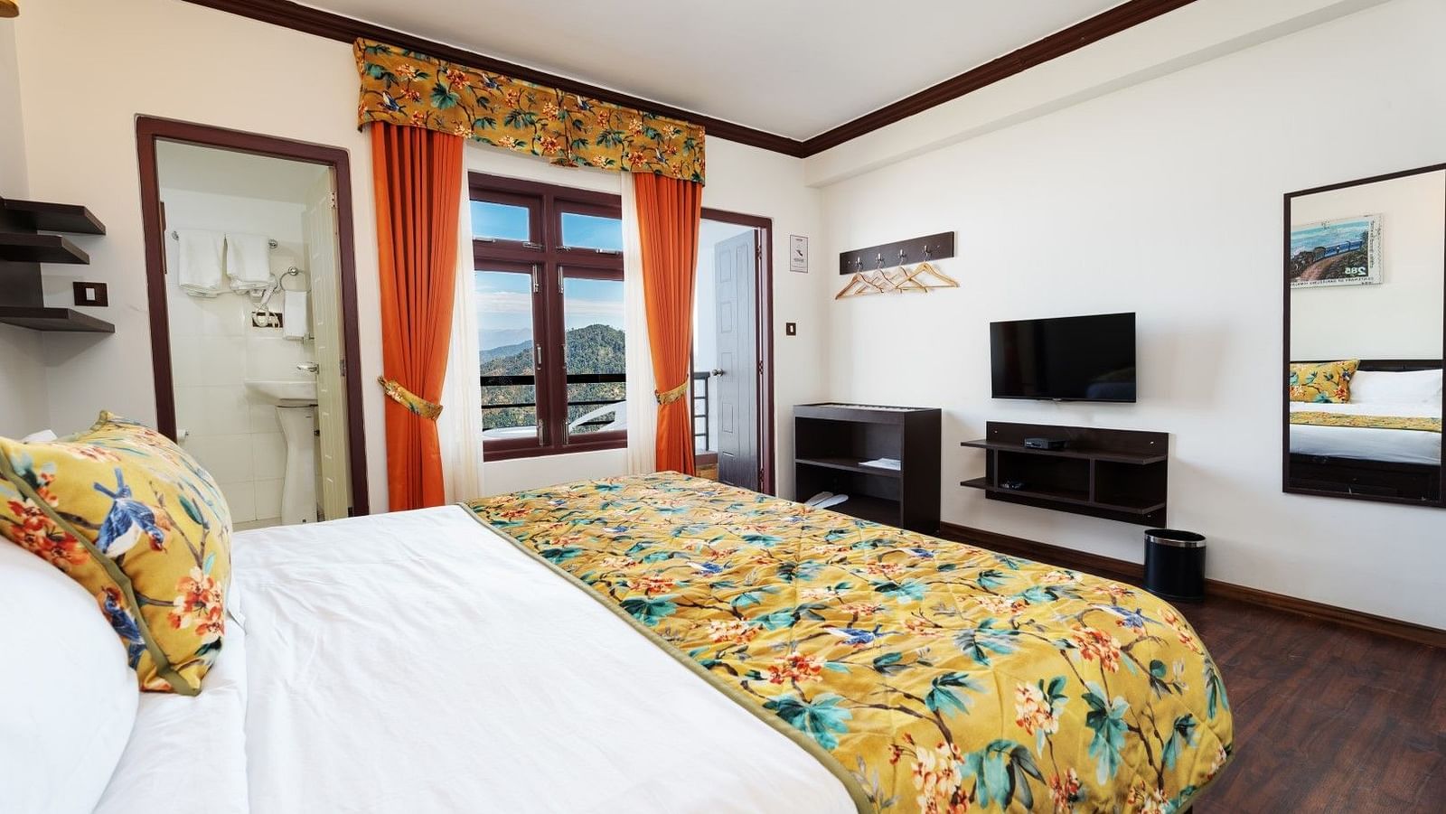 Image of a room with bed and a television in front at Summit Sherpa Mountain Hotel & Spa, Kalimpong