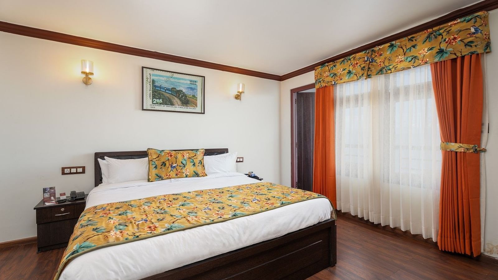 Image of a room with bed and a frame above the bed at Summit Sherpa Mountain Hotel & Spa, Kalimpong