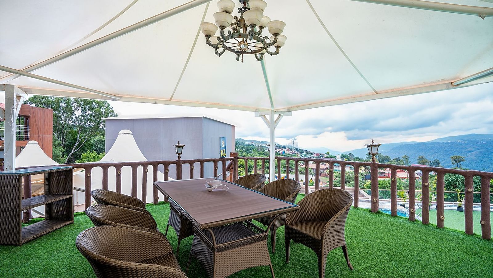 Image of a open air seating area with four chairs and a small table | The Grand Legacy Resort and Spa