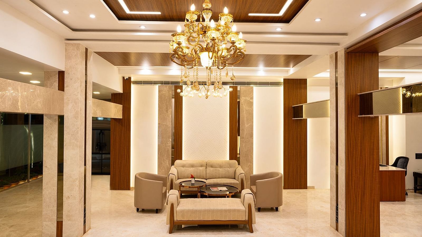 Image of the lobby at the resort featuring four couch and chandelier | The Grand Legacy Resort and Spa