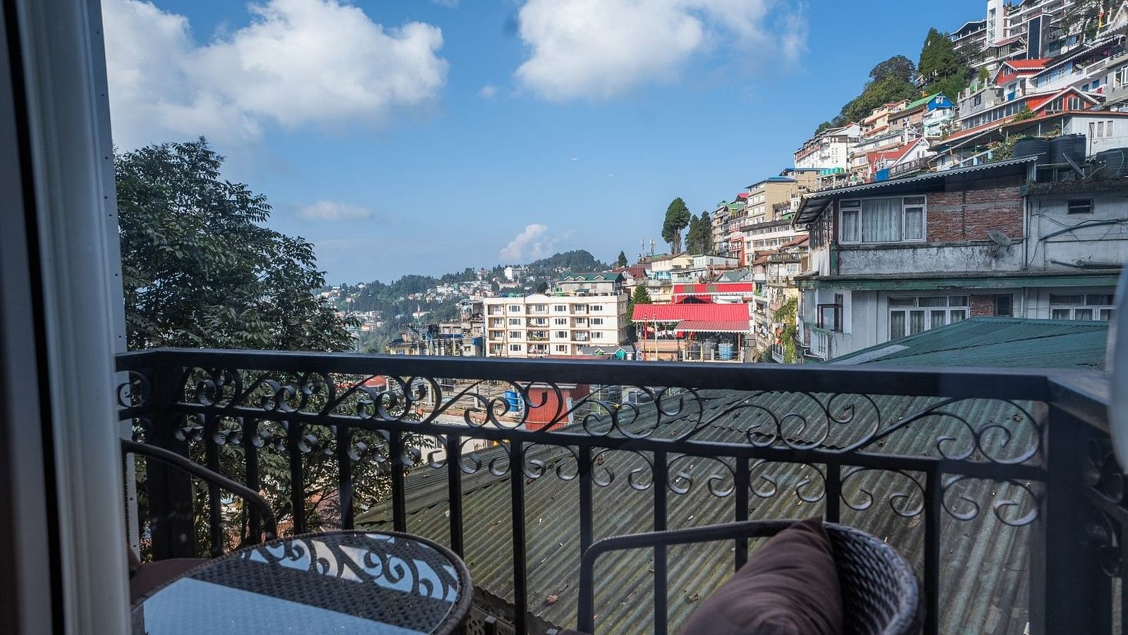 Shot of the private balcony overlooking the surroundings with chairs and table.