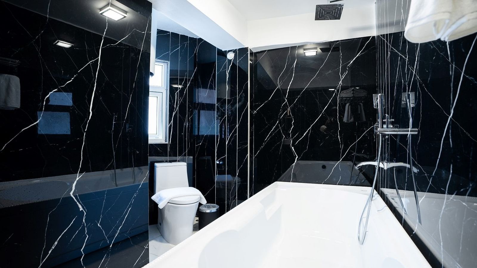 A shot of a bathtub in the washroom of the hotel.