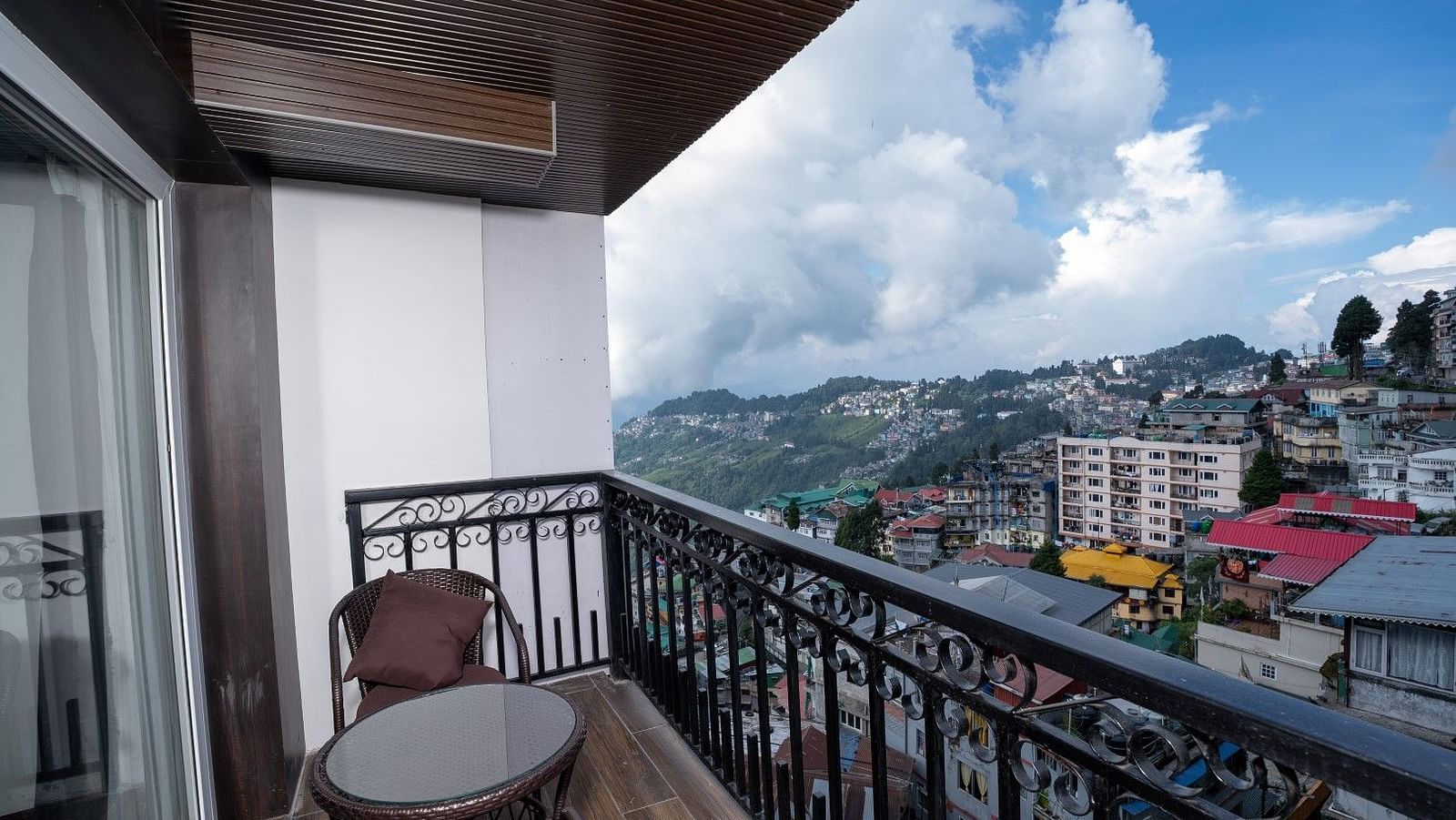 Shot of the private balcony overlooking the surroundings with chairs and table.