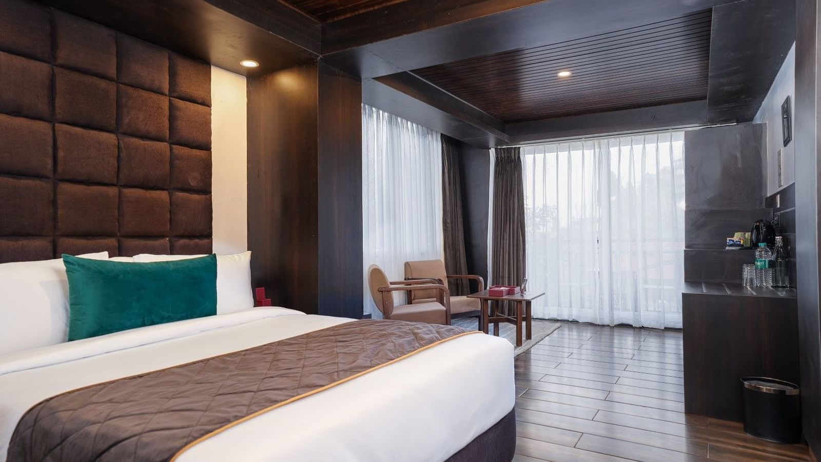 Image of a room that is well furnished with a king size bed and also has an access to a private balcony