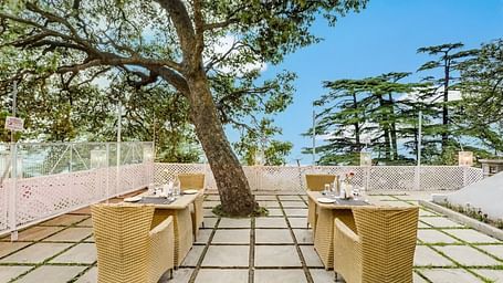 Outdoor dining area at Summit Le Royale Hotel
