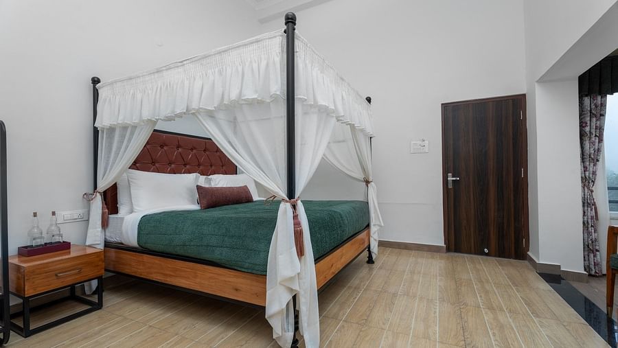 A large bed with abundant lighting, paired with wooden furnishings