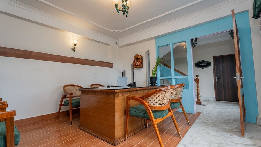 Wooden chairs and tables are orderly arranged in the dining area