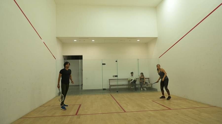 People playing in the squash court at Singalila Club