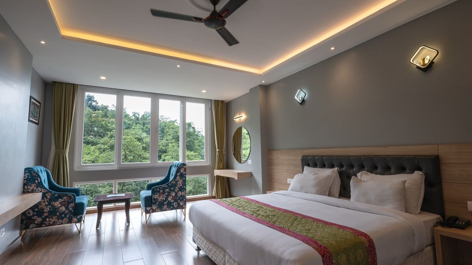 Image of Executive Room featuring a plush bed and a seating space next to a large window