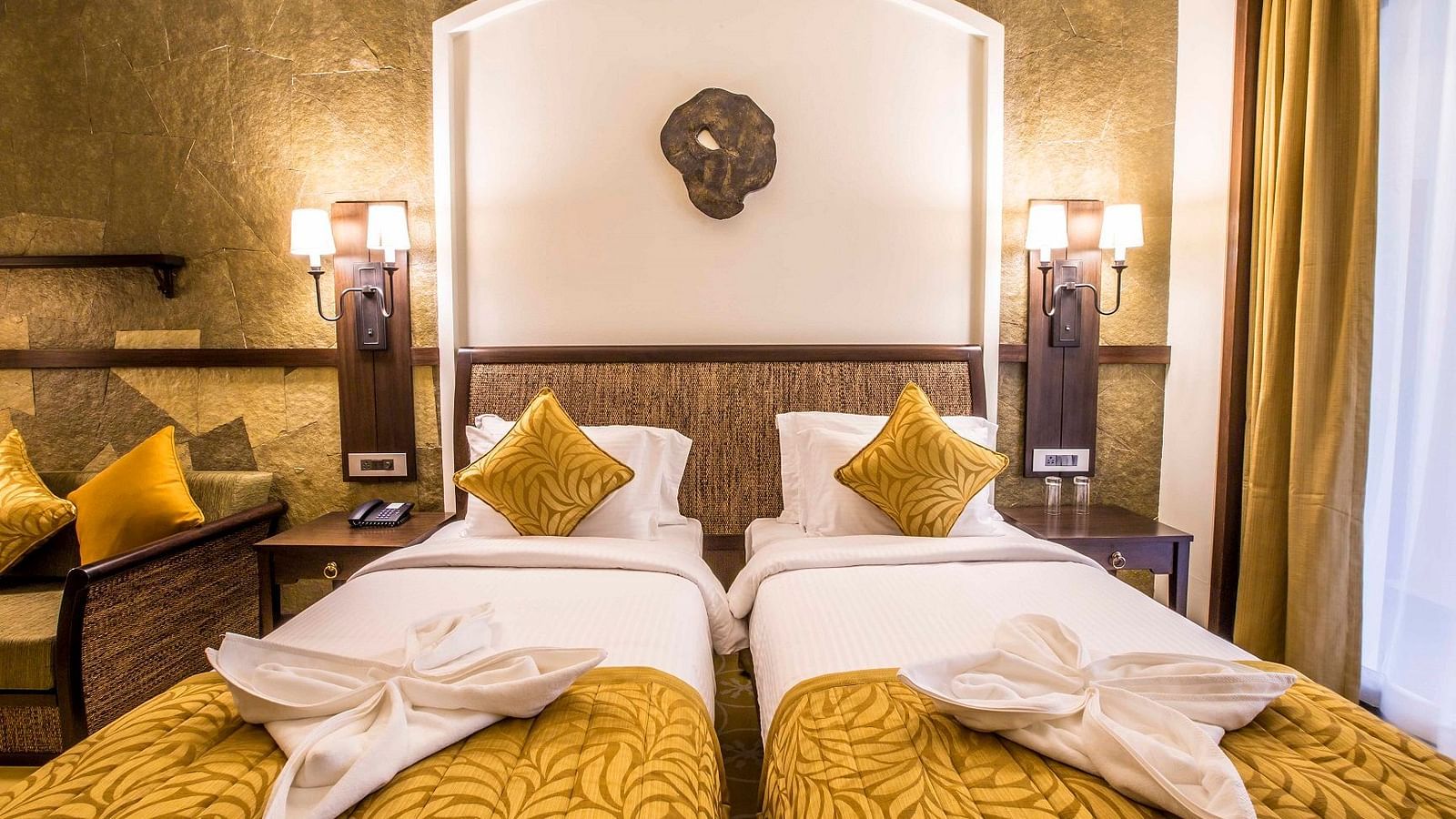 an image of a twin bedroom covered with yellow bedspread at Rhythm Lonavala
