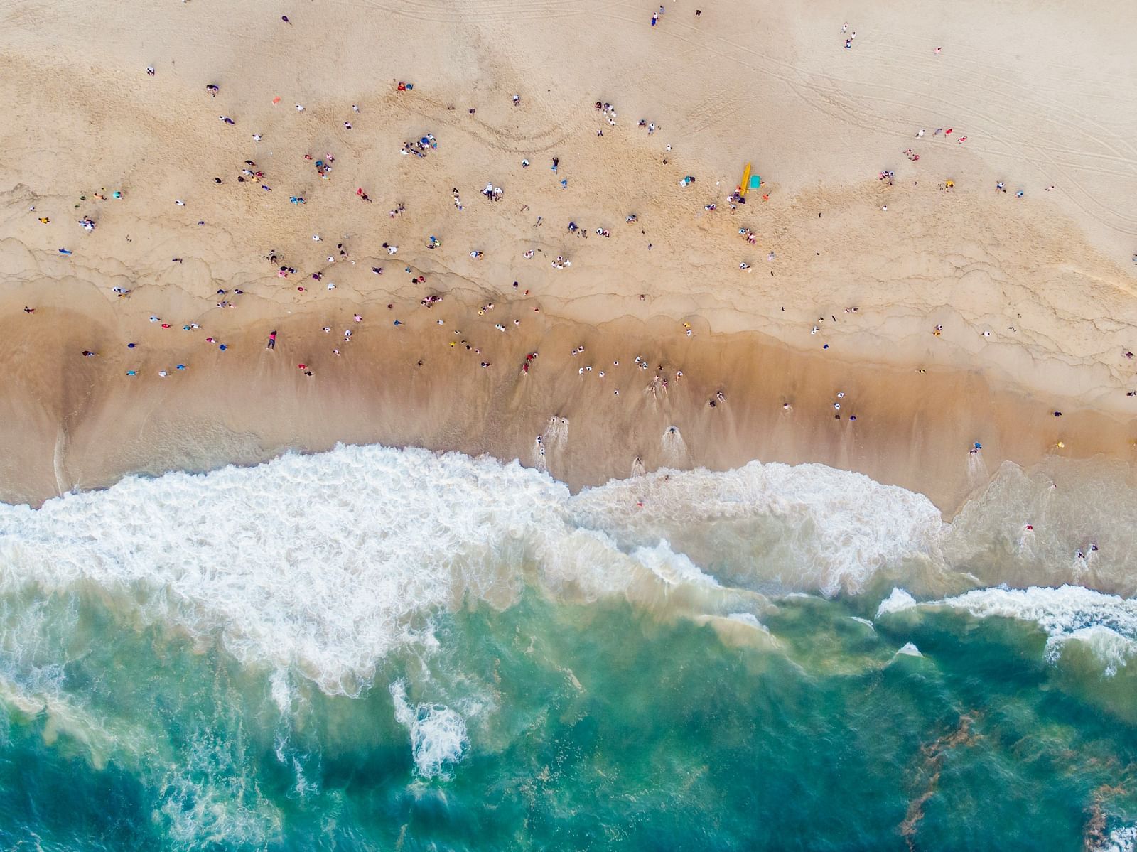 An aerial view of Calangute Beach with people flocking towards the beach