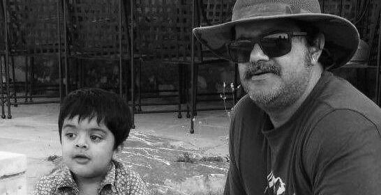 A black and white image of Luv Shekhawat with a toddler