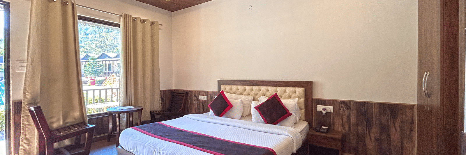 Luxury Cottage with a large bed at DLS MJ River Resort, Rishikesh.