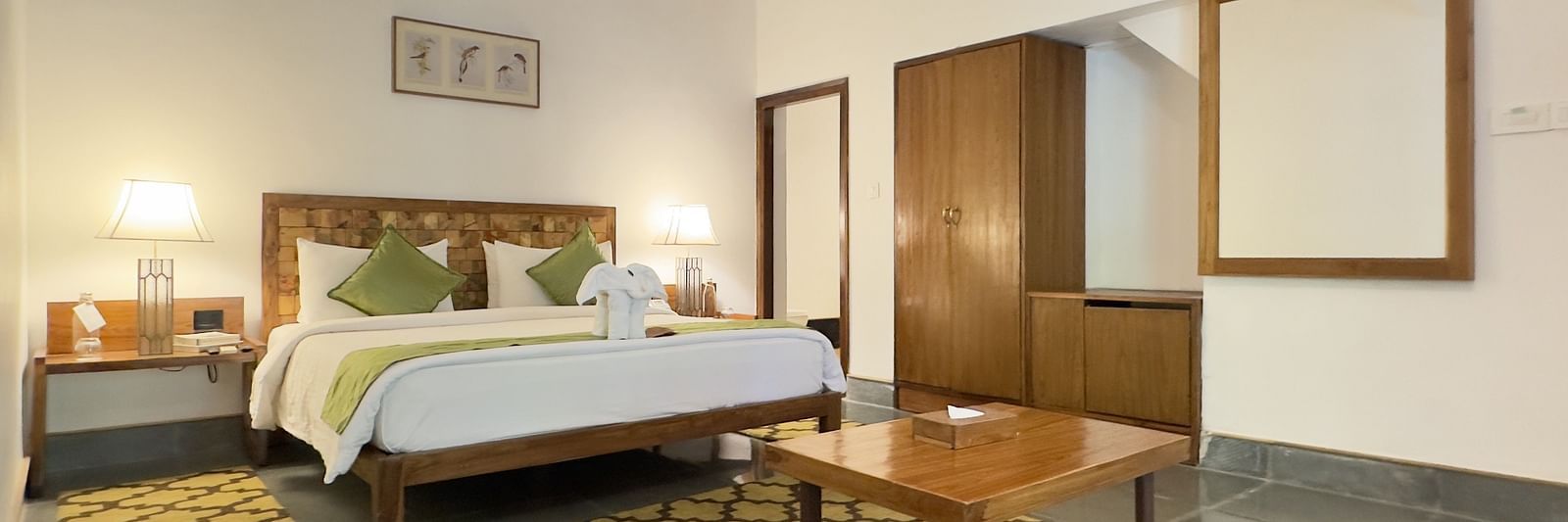 Sanctuary Suite at Saraca Resort & Spa Corbett with a double bed, side tables and a wardrobe