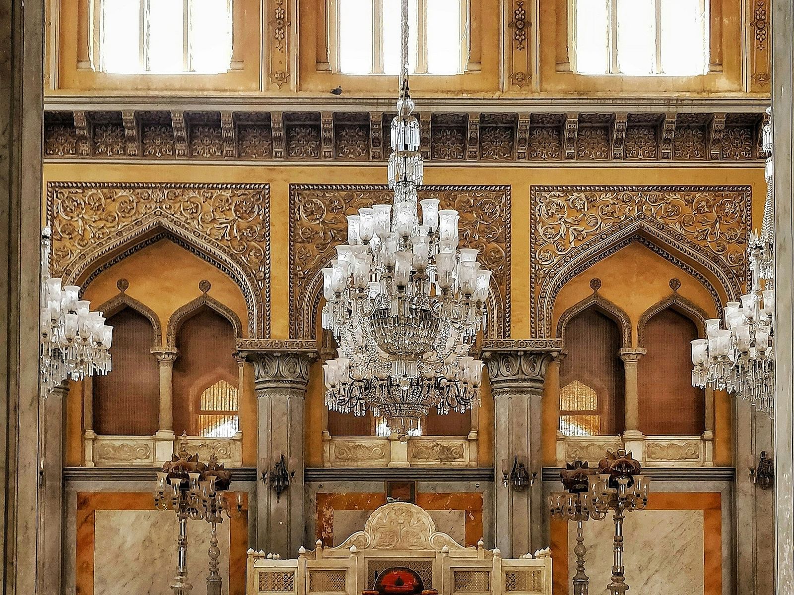 a chandelier hanging from the ceiling of a palace